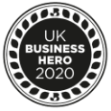 A circular emblem with a laurel wreath border and the text "UK Business Hero 2020" in the center. The design is monochromatic, featuring a dark background and lighter text and patterns.
